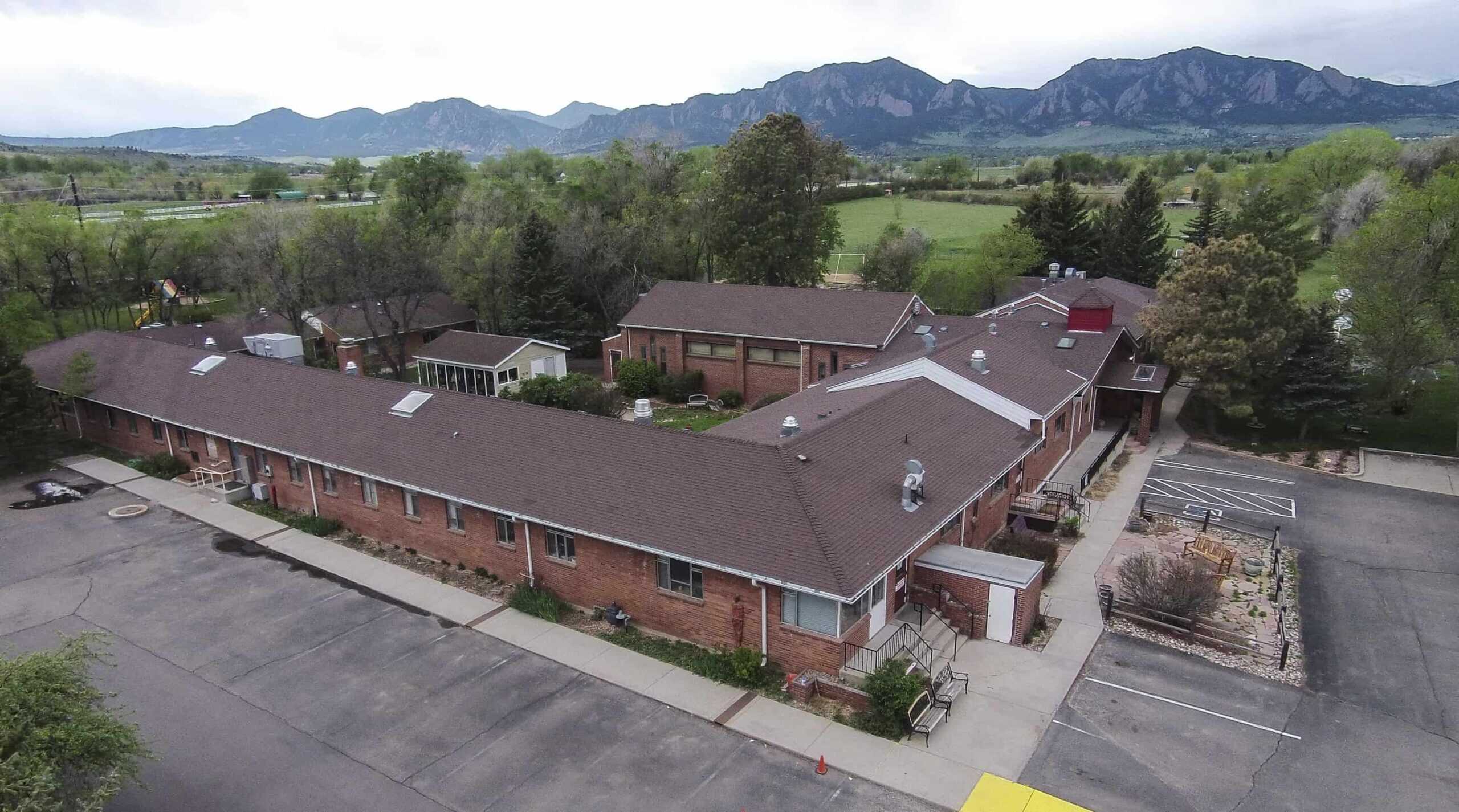 Mack Boulder Campus with the Boulder, Colorado Flatirons mountains in the background.